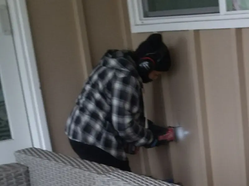 Professional electrician installing an exterior outlet in Woodlawn